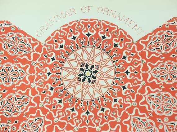 Decorative book page with a red pattern and "Grammar of Ornament" in red lettering.