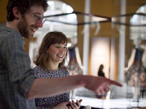 Two visitors observing a display in the museum.
